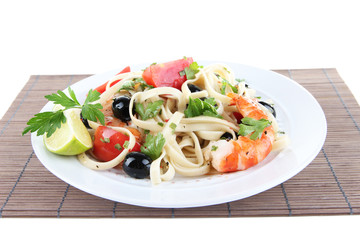 Fresh prawns with spaghetti, olives, tomatoes and parsley in a