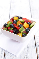 Delicious fruits salad in plate on table close-up