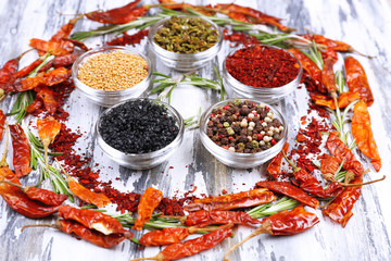 Spices with herbs and dried chilly pepper on wooden background