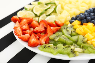 Sliced fruits on plate on table