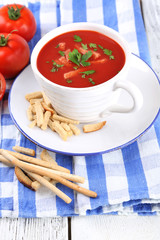Tasty tomato soup with croutons on table close-up