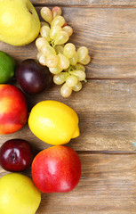 Naklejka na ściany i meble Assortment of juicy fruits on wooden background
