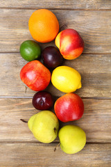 Assortment of juicy fruits on wooden background