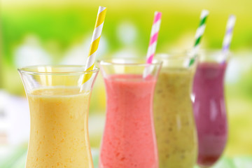 Delicious berry cocktails on table on bright background