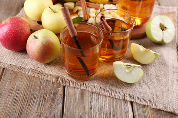 still life with apple cider and fresh apples on wooden table