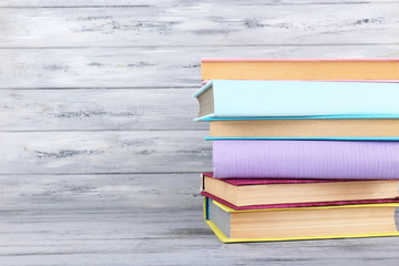 color books on grey wooden background
