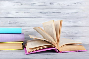 color books on grey wooden background