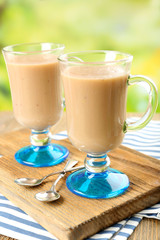 Delicious berry mousse in glasses on table on bright background
