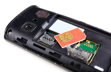Sim card and smart phone isolated on white