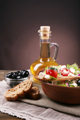 Obraz na płótnie Canvas Bowl of Greek salad served with olive oil