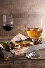beautiful still life with wine, cheese and ripe grape