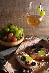 beautiful still life with wine, cheese and ripe grape