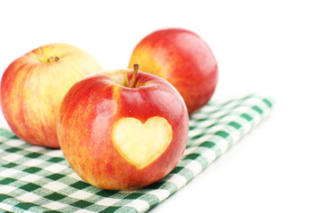 Red apple with heart isolated on white