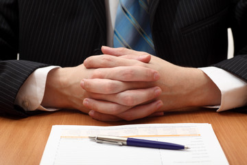 Businessman sitting at a desk with documents