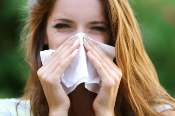 Young girl with allergy outdoors