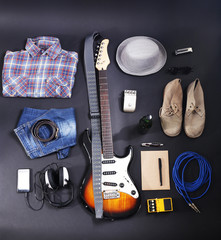 Musical equipment, clothes and footwear on dark background