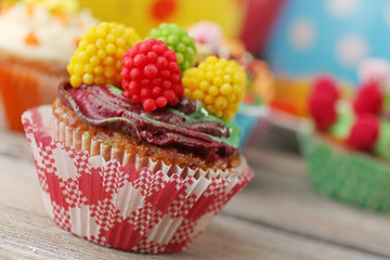 Delicious birthday cupcakes on table close-up