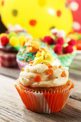 Fototapeta na wymiar Delicious birthday cupcakes on table close-up
