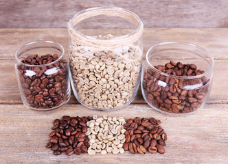 Coffee in glass jars on wooden background
