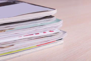 Magazines on wooden table close up