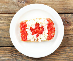 Sandwich with flag of Canada on table close-up