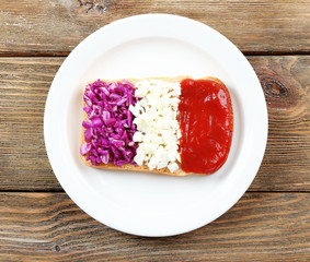 Sandwich with flag of France on table close-up