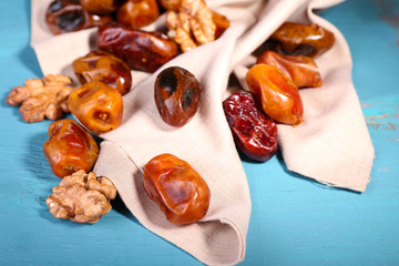 Tasty dates fruits on blue wooden table