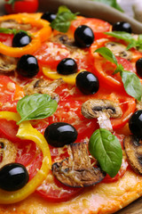 Delicious pizza served on wooden table