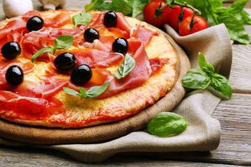 Delicious pizza served on wooden table