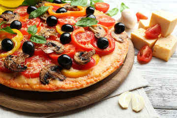 Delicious pizza served on wooden table