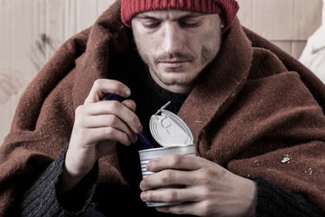 Frozen homeless man eat