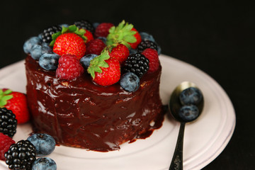 Tasty chocolate cake with different berries