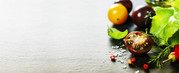 Fresh grape tomatoes with salade leaves and salt
