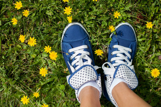 Blue sneakers on girls feet