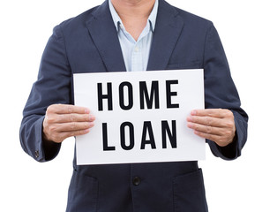 Business man hand holding home loan banner isolated on white bac
