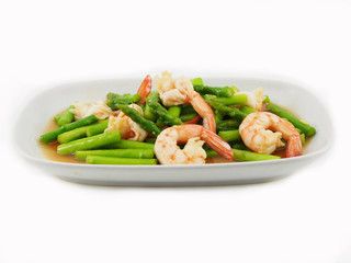Stir fried shrimps with asparagus in plate on white