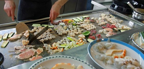chef prepares dishes with vegetables