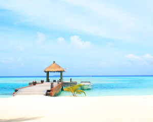 Overwater villas in blue tropical lagoon
