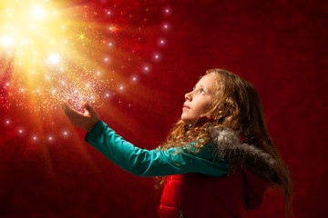 Young girl touching stars.
