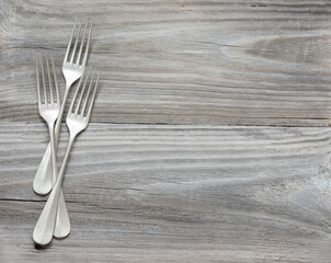 Three vintage fork on old wooden boards