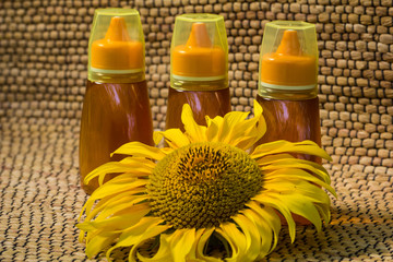 Honey in jar and sunflower