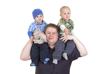 Father carrying his twin children on shoulders