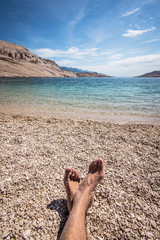 male feet on the beach - relax concept