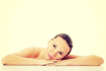 Fototapeta premium Beautiful nude woman is lying on her hands.