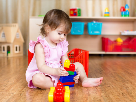 child girl playing with block toys indoor