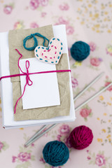 Old notebook for love notes, bright yarn balls and needles
