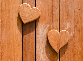wooden hearts shaped on wooden background