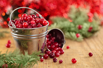Cranberries in buckets against de-focused holiday lights backgro
