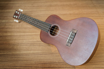 Fototapeta premium Vintage ukulele on wooden background