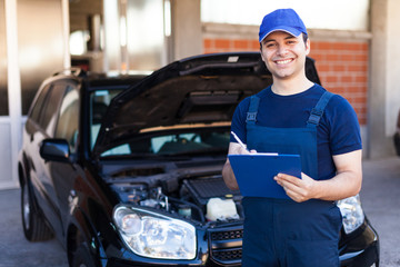 Mechanic writing on a clipboard